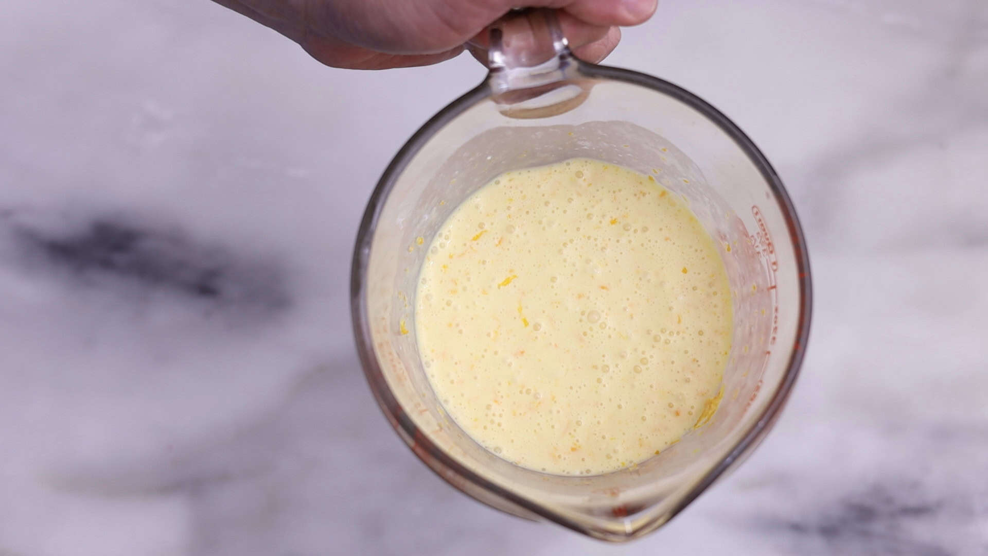 In a separate bowl, whisk together the cold heavy cream, orange juice, Grand Marnier, vanilla, zest, and eggs until combined. 2