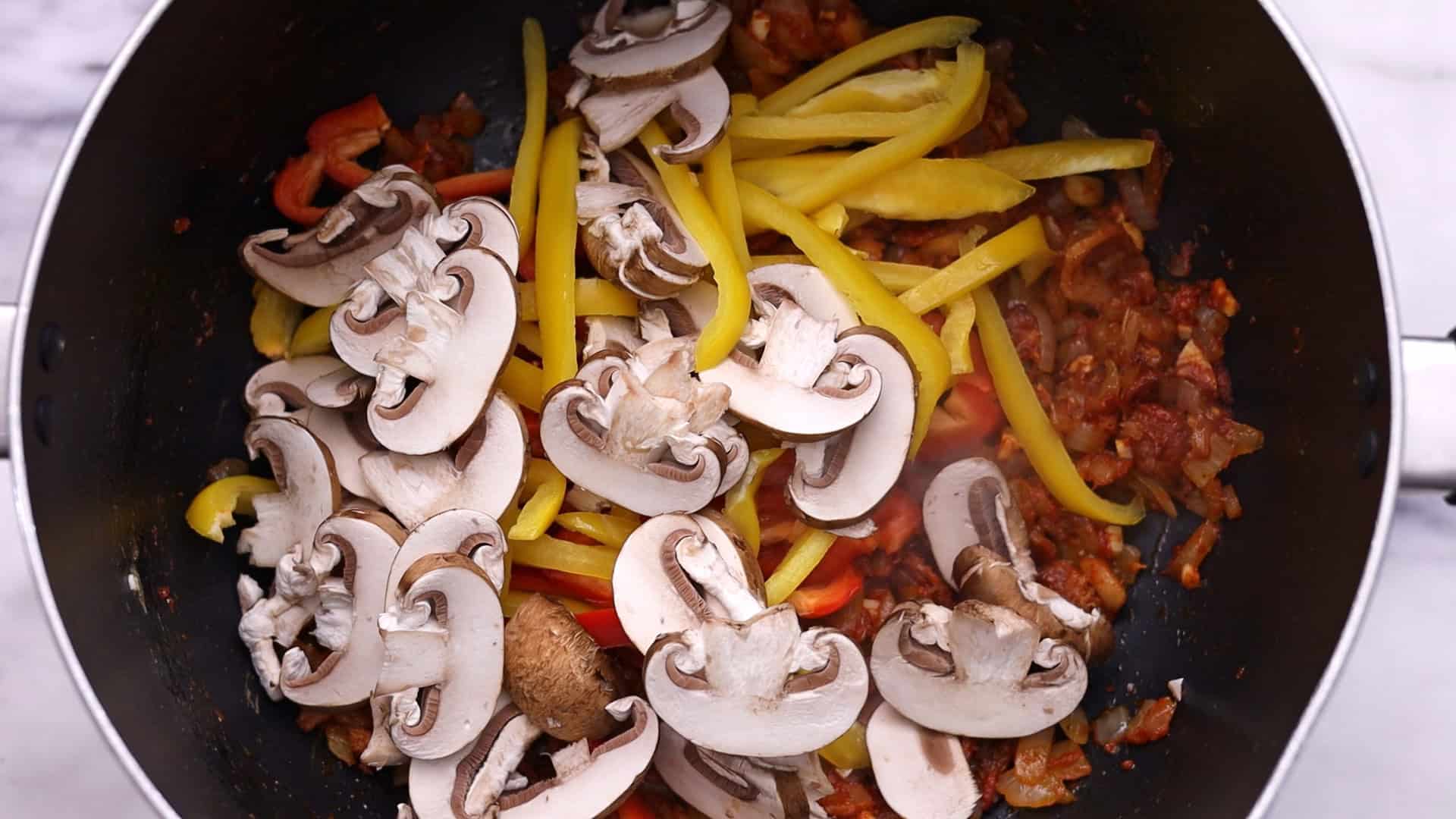 Add mushrooms and peppers, and cook until softened.