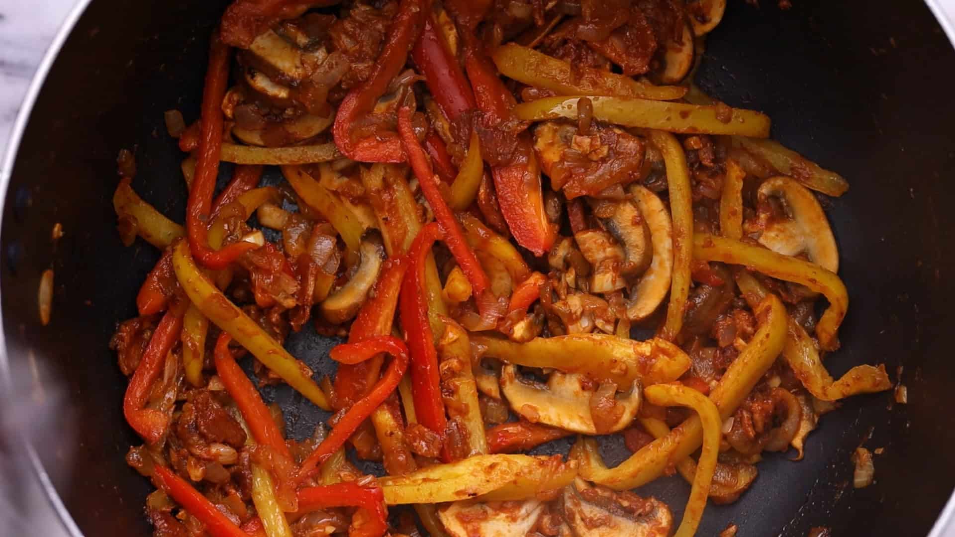 Add mushrooms and peppers, and cook until softened.