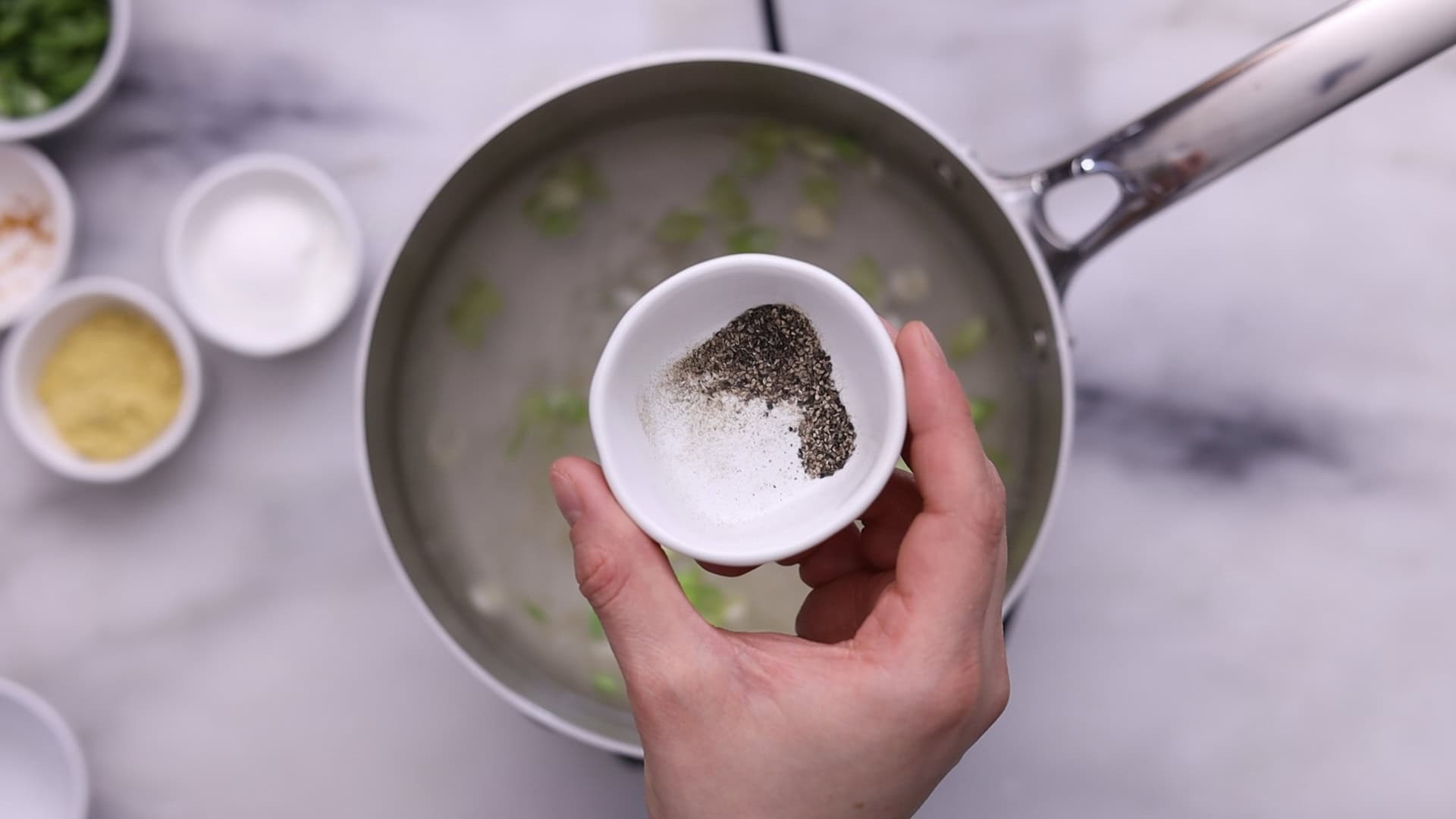 Add water, bring to a boil, and stir in turmeric, pepper