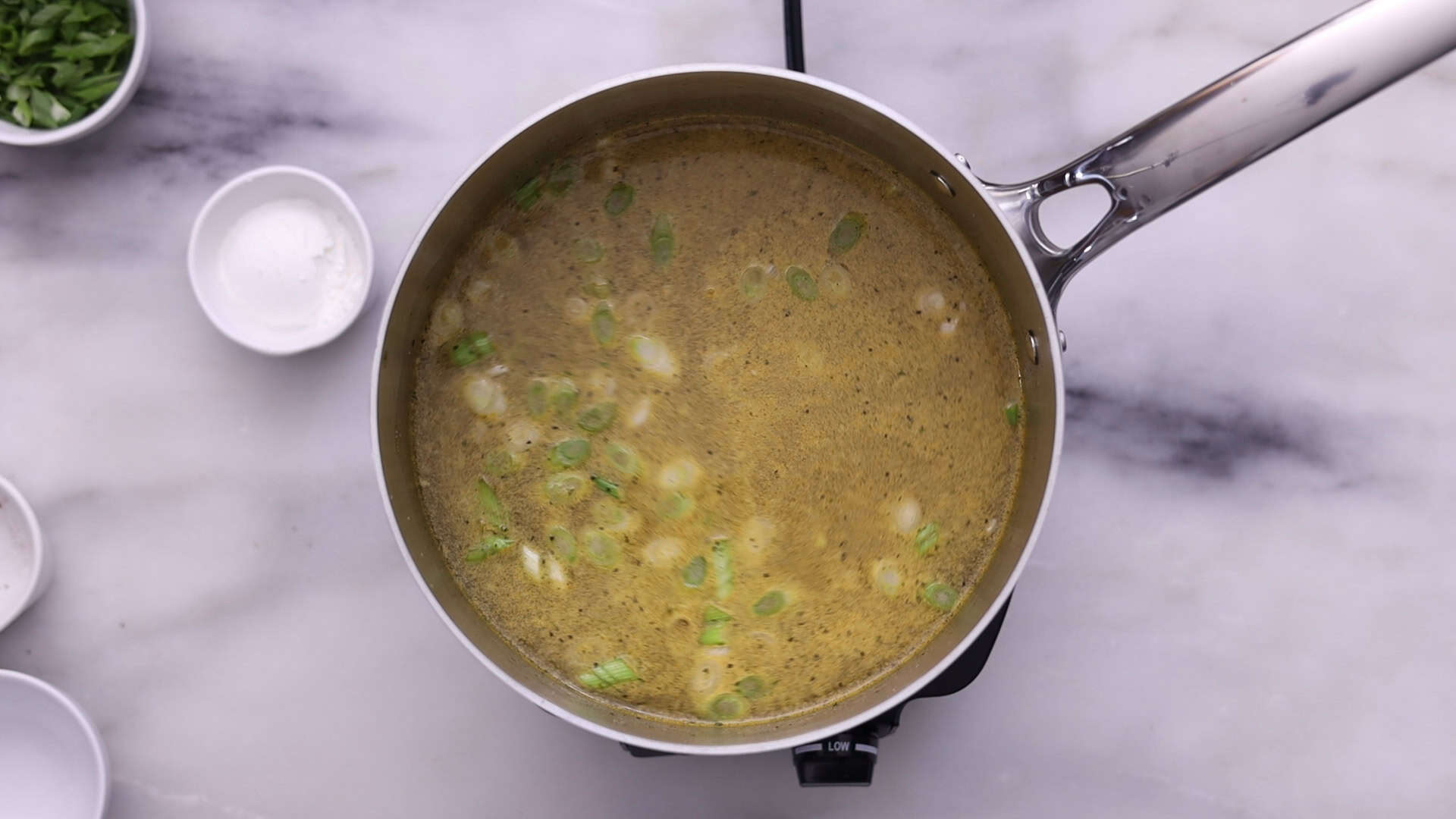 Add water, bring to a boil, and stir in turmeric, pepper, and bouillon; simmer covered to blend flavors.