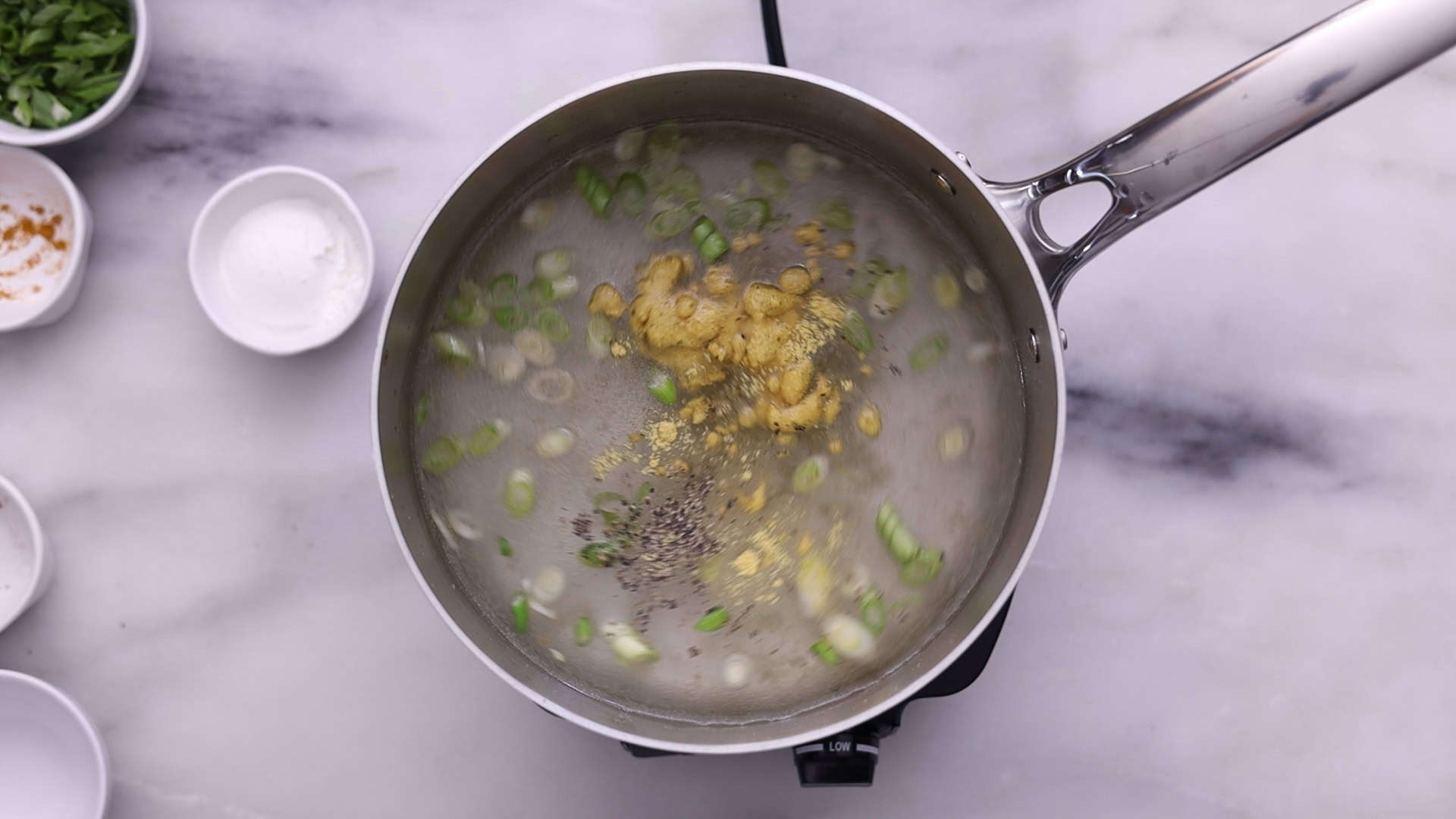 Add water, bring to a boil, and stir in turmeric, pepper, and bouillon; simmer covered