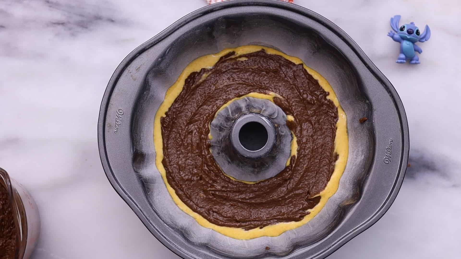 Marble Bundt Carrot Cake 31 Alternate spooning carrot and chocolate batter into pan.