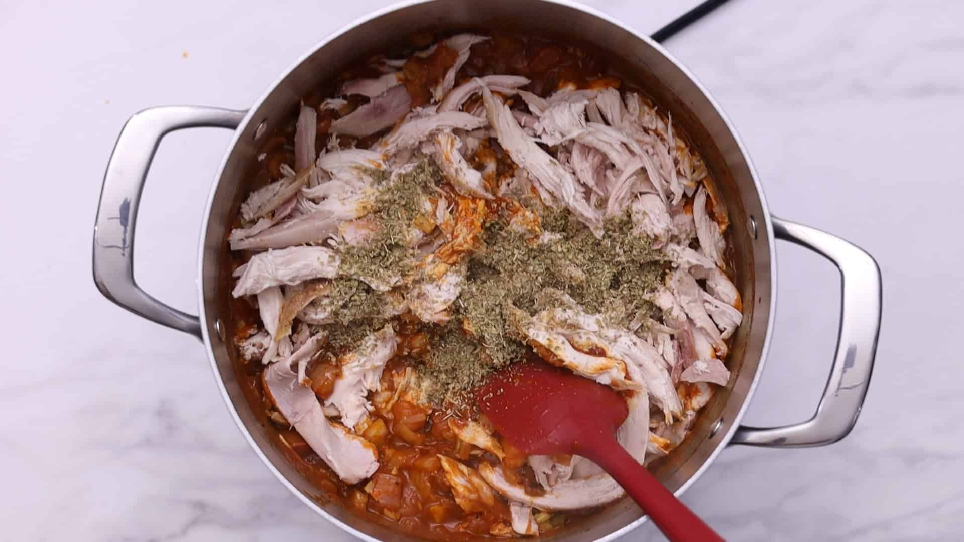 Stir in the oregano, paprika, and shredded chicken