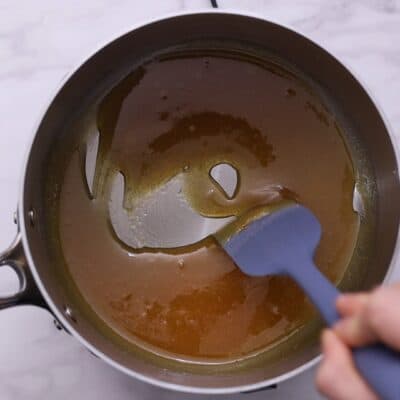 Heat sugar in a saucepan over medium heat, stirring until golden caramel forms. 