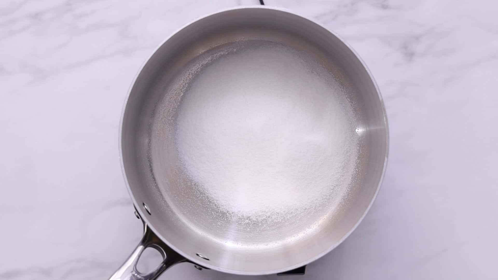Heat sugar in a saucepan over medium heat, stirring