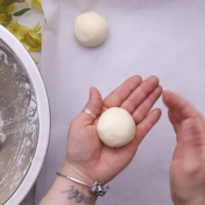 Knead, form 50 g balls, and place on the baking sheet.