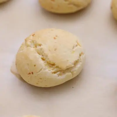 Knead, form 50 g balls, and place on the baking sheet. Bake 15-20 minutes until lightly golden brown