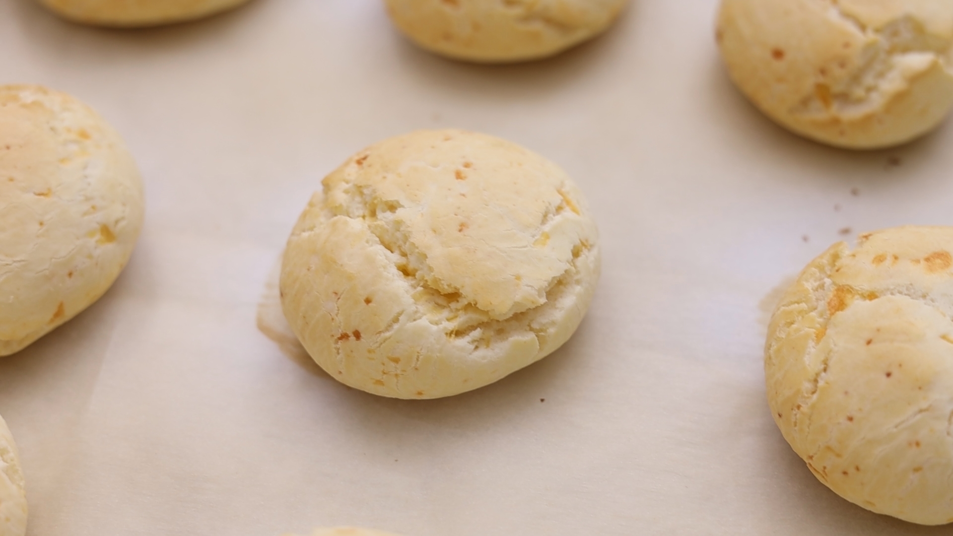 Knead, form 50 g balls, and place on the baking sheet. Bake 15-20 minutes until lightly golden brown