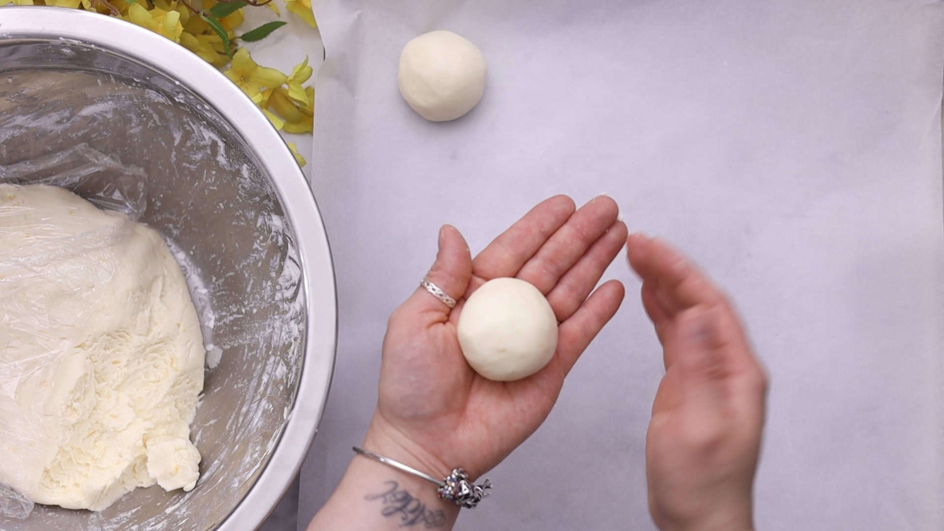 Knead, form 50 g balls, and place on the baking sheet.