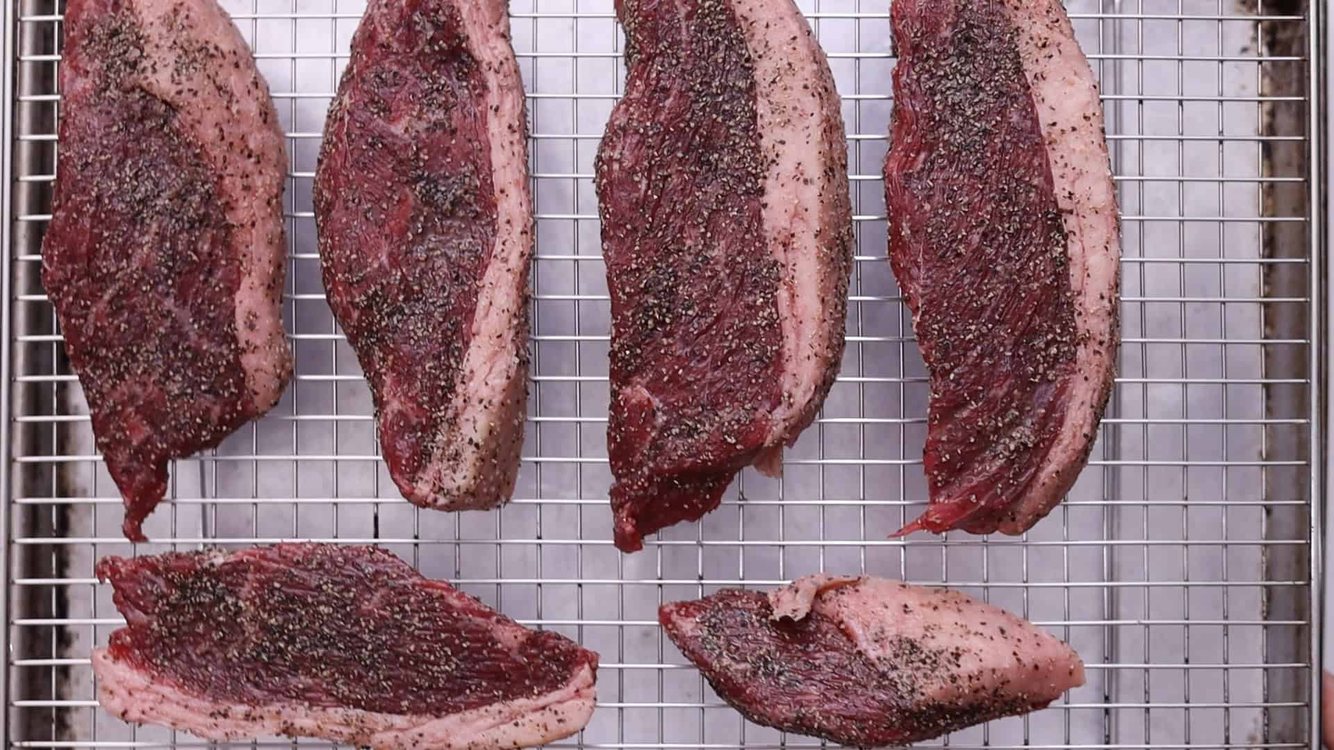 Place on a broiler pan or wire rack set on a baking sheet, fat side up if whole. Add ½ cup of water to the pan.2