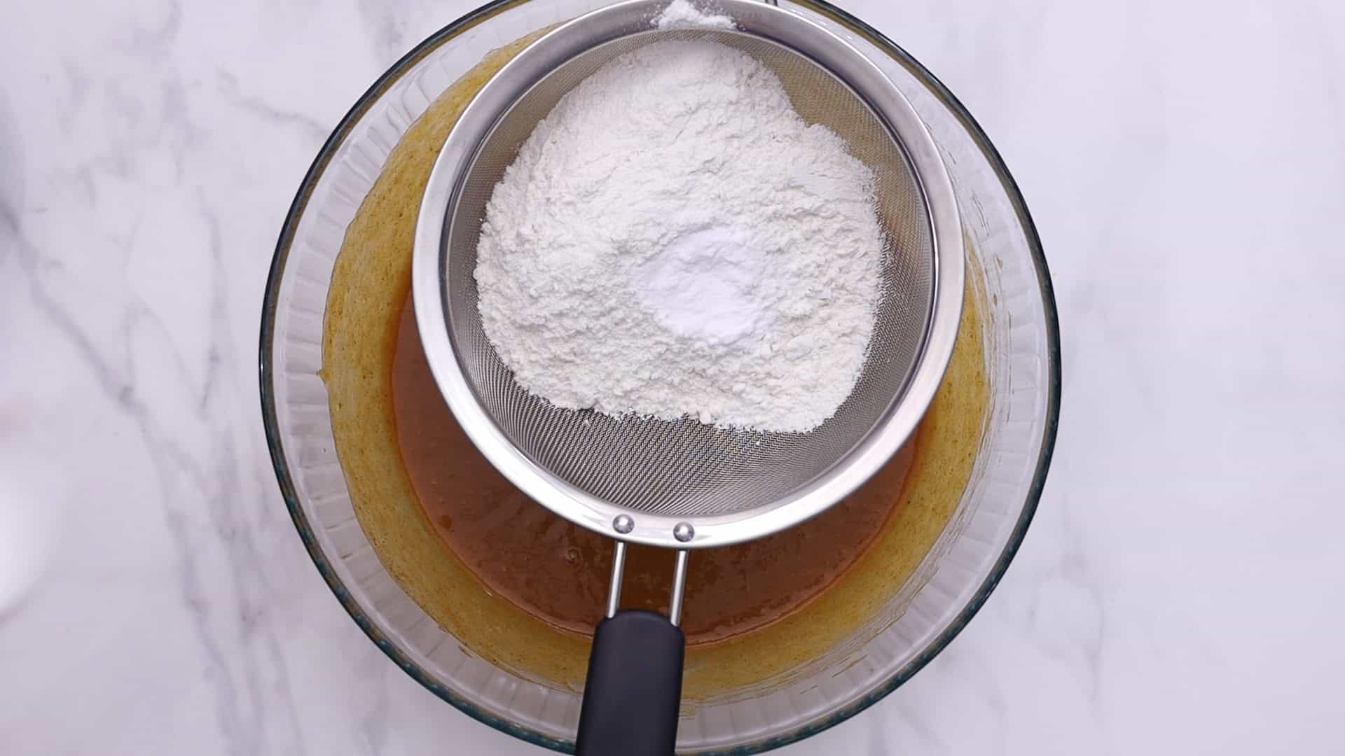 Sift flour, baking powder, baking soda, cinnamon, and nutmeg.