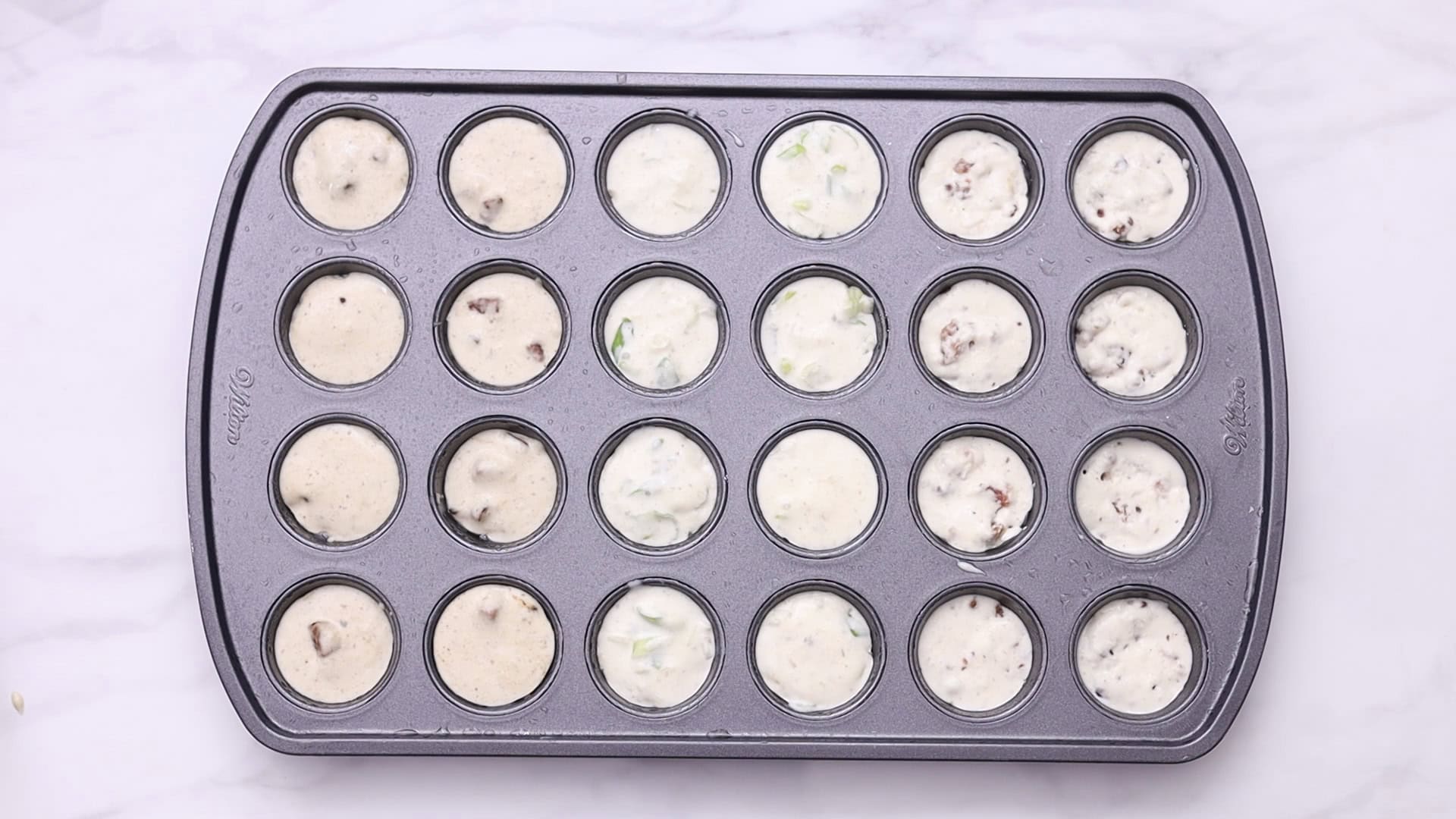 Spray a 24-cup mini muffin pan with oil and fill it with batters