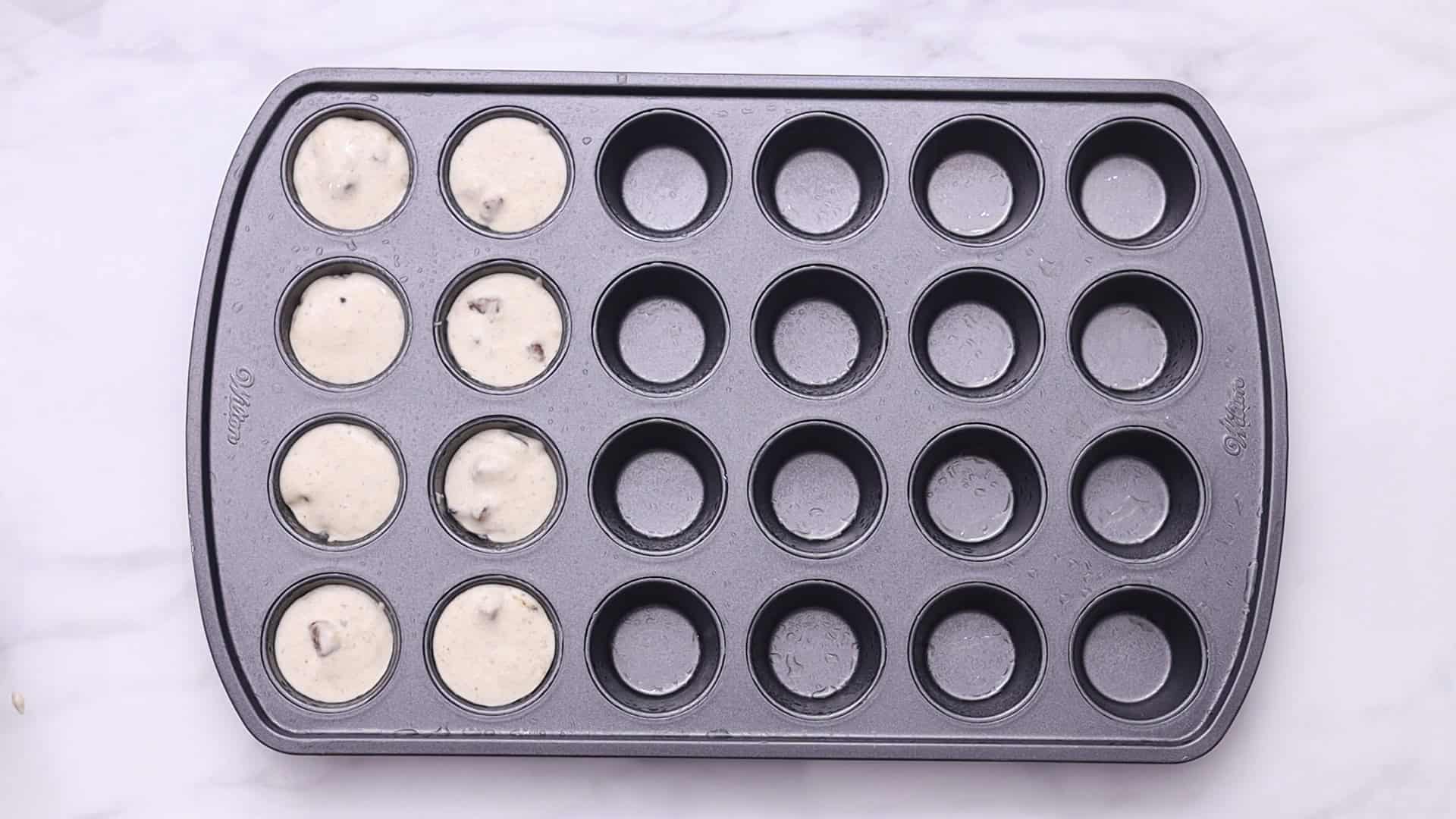 Spray a 24-cup mini muffin pan with oil and fill it with batters.