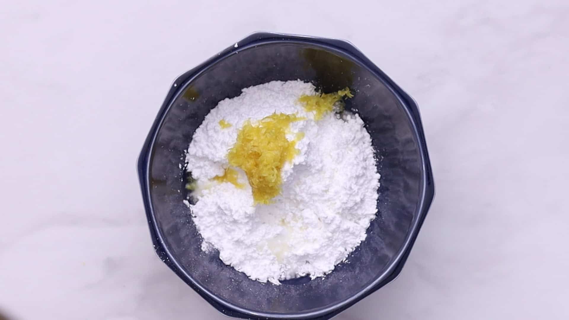 Mix powdered sugar, lemon zest, and juice for glaze. Adjust consistency.