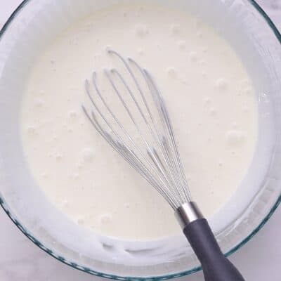 Whisk condensed milk, water, and plain yogurt for 2 minutes._1.55.1