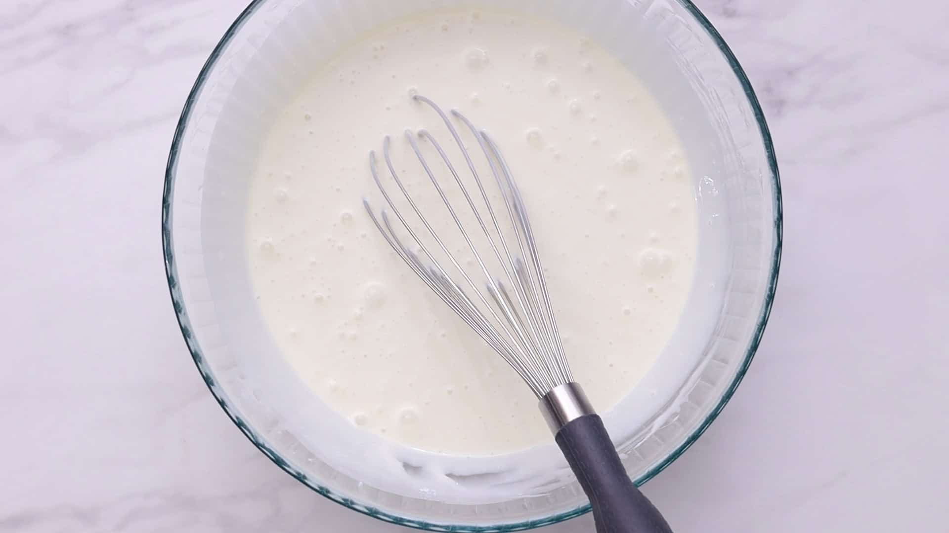 Whisk condensed milk, water, and plain yogurt for 2 minutes._1.55.1