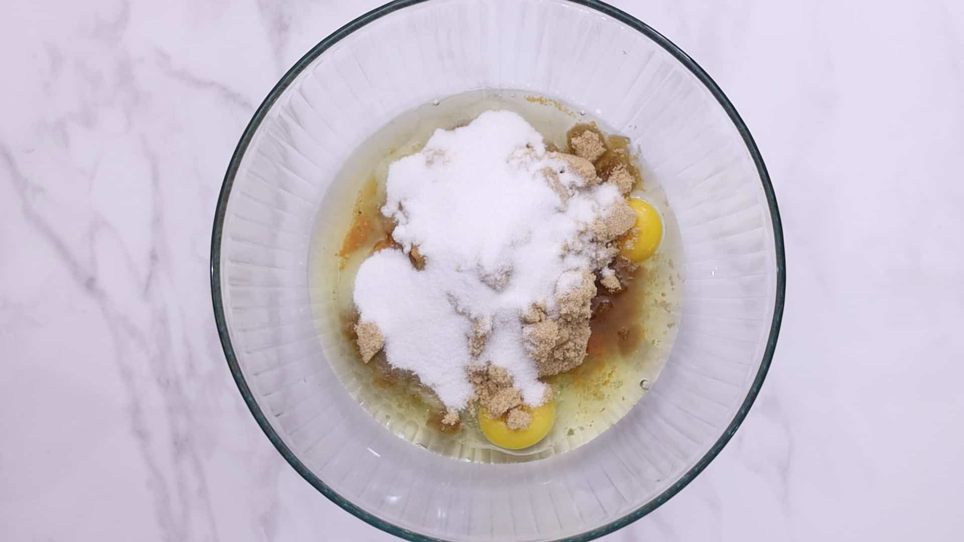 Whisk eggs, sugars, pumpkin puree, oil, and vanilla.
