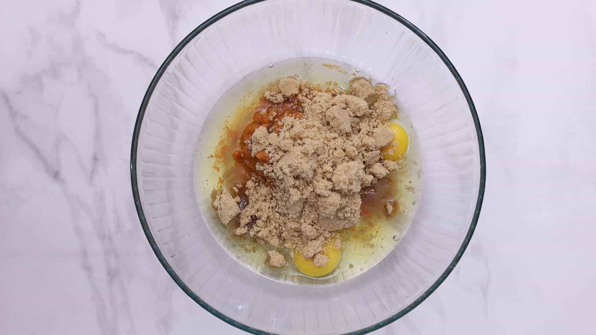 Whisk eggs, sugars, pumpkin puree, oil, and vanilla