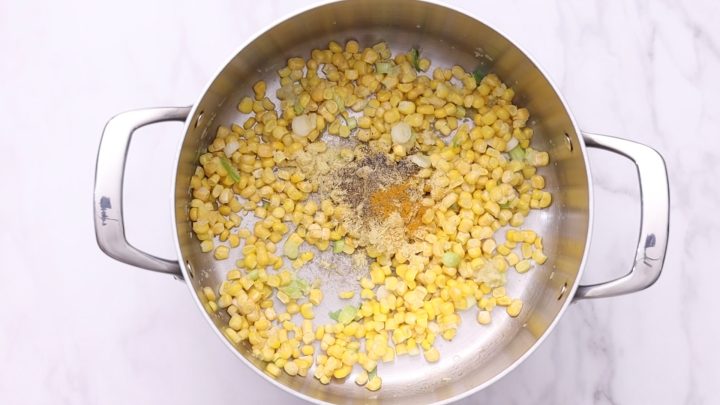 Stir in corn, turmeric, black pepper, and chicken bouillon.