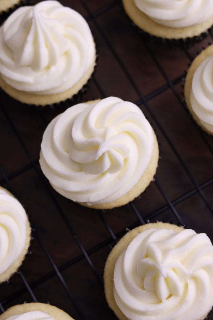 A cooling rack with cupcakes on it.