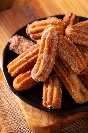 Churros Mexicanos in a black plate