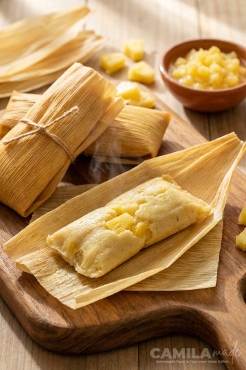 Tamales de Piña in a wooden cutting board