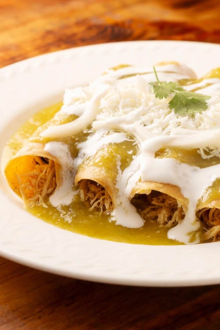 Turkey Enchiladas with cheese in a white plate