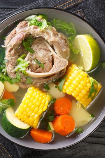 Caldo de Res top view in a black bowl