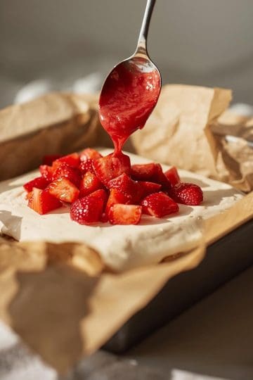 pouring the strawberry preserves on the Strawberry Vanilla Cake
