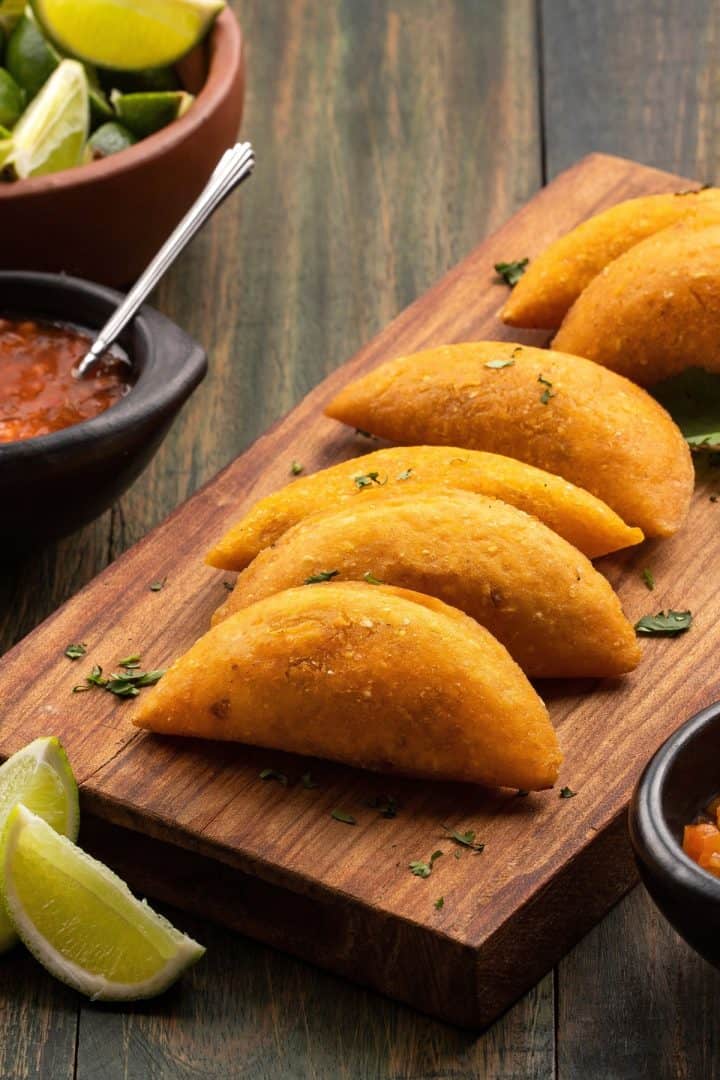 Empanadas de Plátano side view with salsa