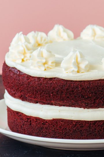 Red velvet cake with cream cheese icing frosting close up