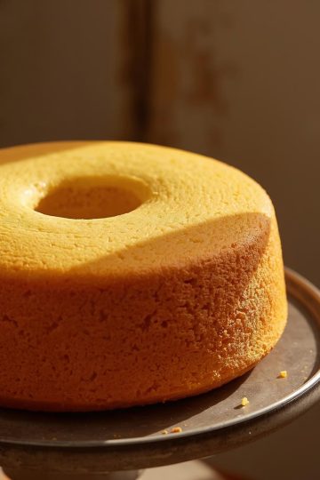 Bolo de Milho 1 A close-up food photograph of Brazilian bolo de milho standing on a plate