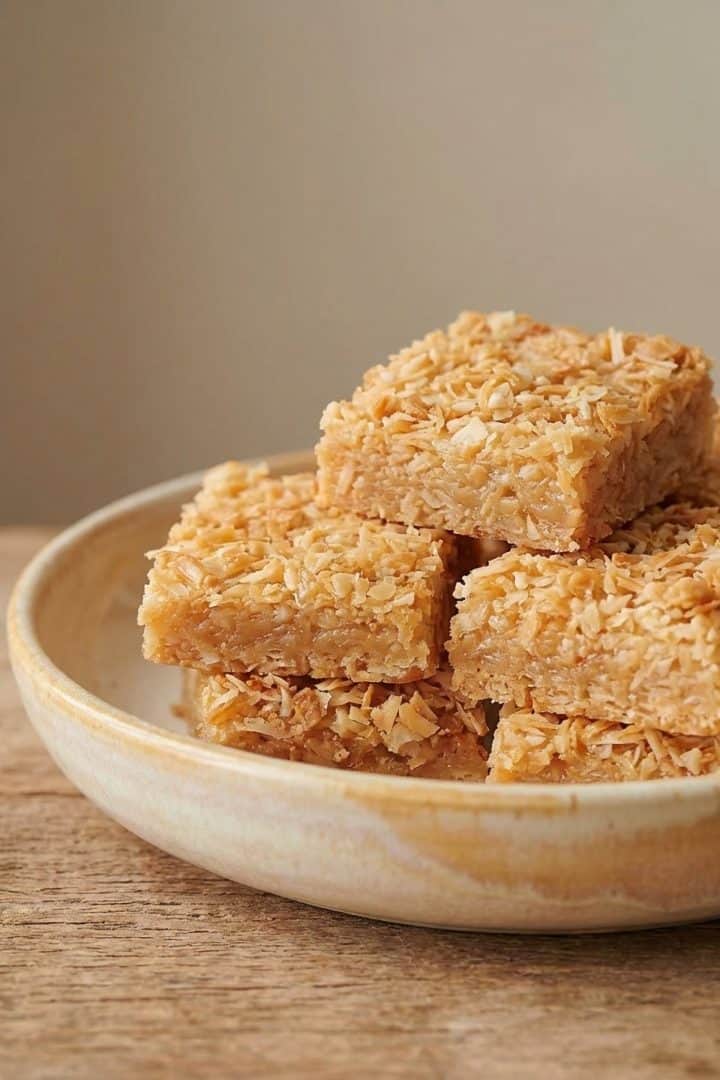Cocada coconut squares arranged on parchment,