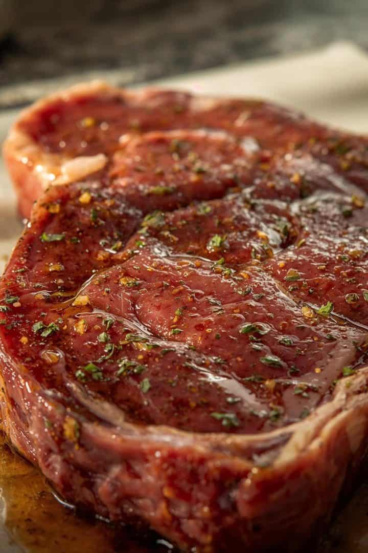 Raw skirt steak fully coated in marinade
